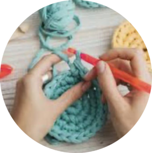 Girl crocheting in a circle with teal yarn