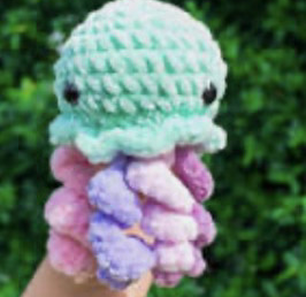 Crochet teal jellyfish with pink and purple tentacles