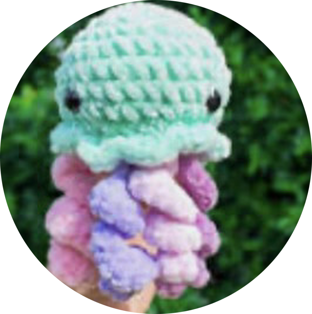 Crochet teal jellyfish with pink and purple tentacles